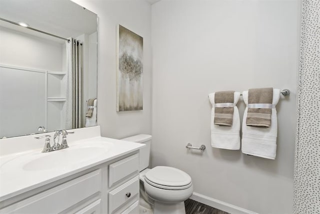 bathroom with a shower with curtain, vanity, toilet, and hardwood / wood-style floors