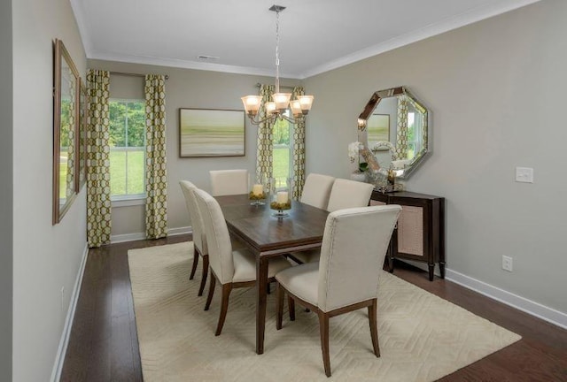 dining space with hardwood / wood-style floors, crown molding, and a notable chandelier