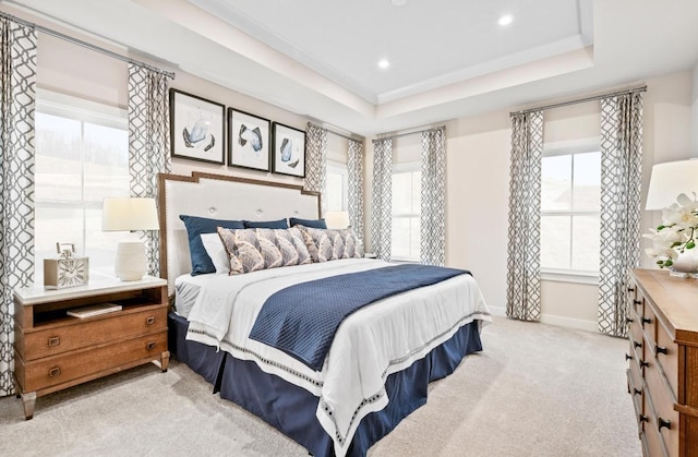 bedroom featuring a tray ceiling and light colored carpet