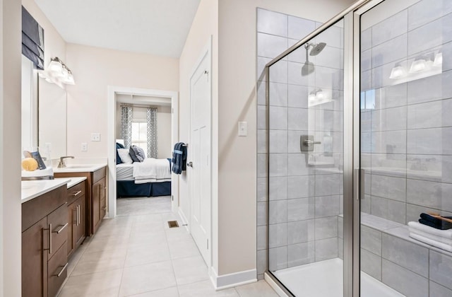 bathroom with vanity, a shower with shower door, and tile patterned floors