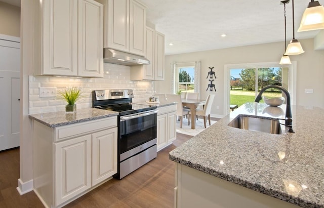 kitchen featuring white cabinetry, stainless steel electric stove, sink, and decorative light fixtures