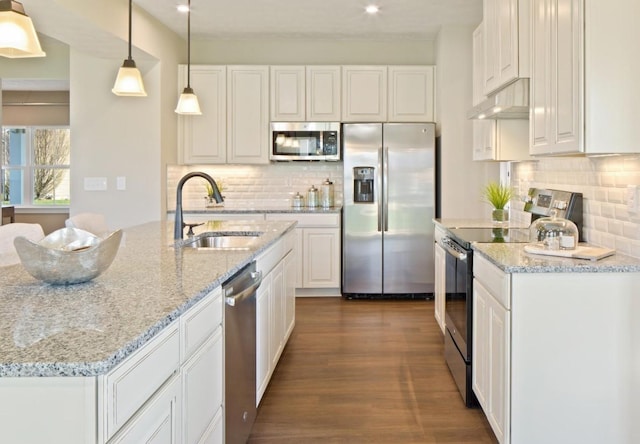 kitchen featuring hanging light fixtures, stainless steel appliances, sink, and white cabinets