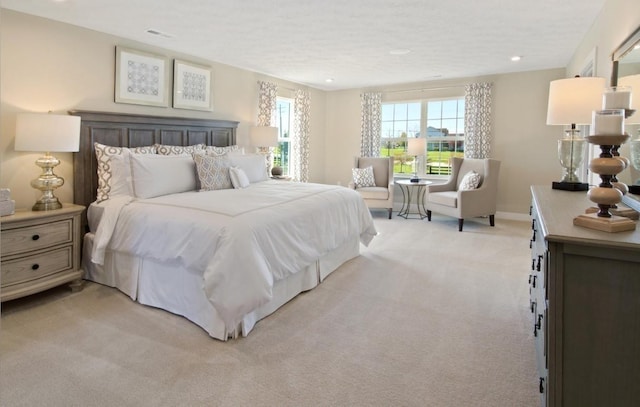 carpeted bedroom with multiple windows and a textured ceiling