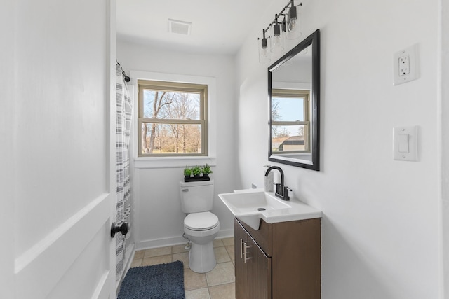 bathroom featuring tile patterned flooring, vanity, and toilet