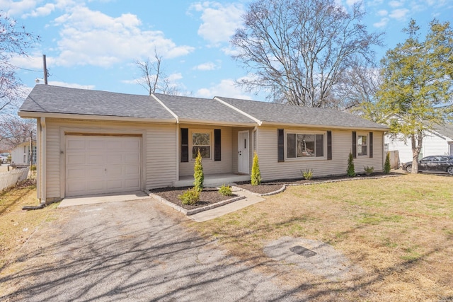 ranch-style house featuring a garage and a front lawn