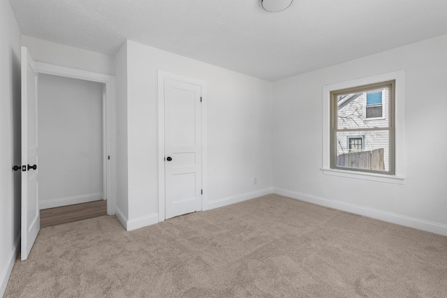 unfurnished bedroom featuring light carpet