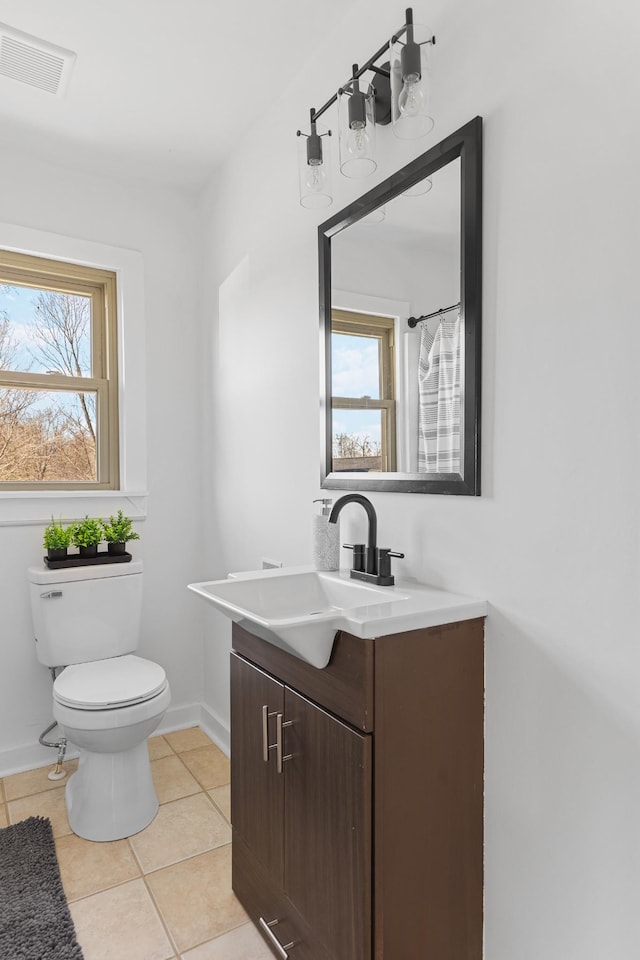 bathroom featuring tile patterned flooring, vanity, and toilet