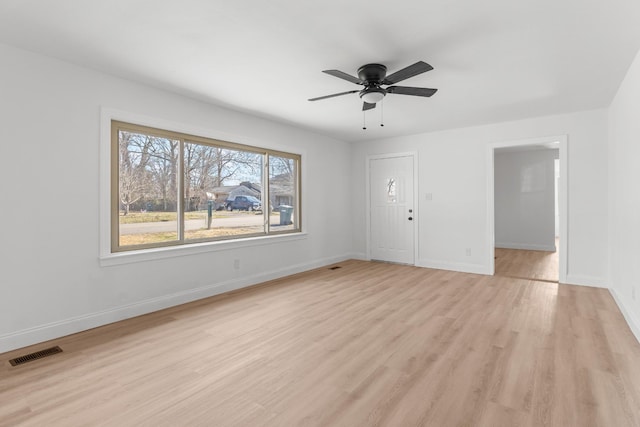 spare room featuring ceiling fan and light hardwood / wood-style flooring