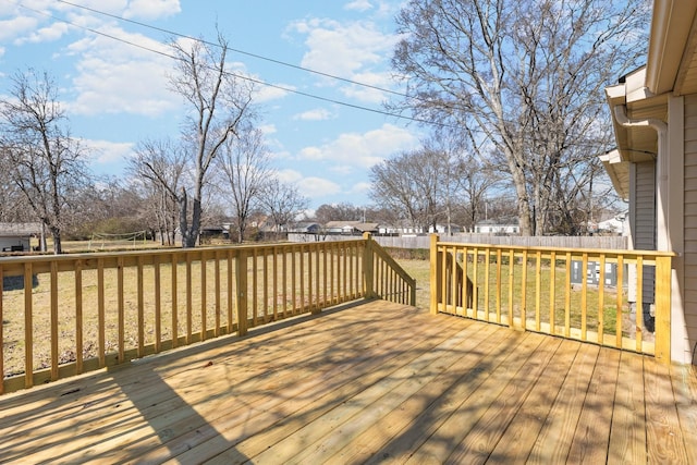 wooden terrace featuring a lawn