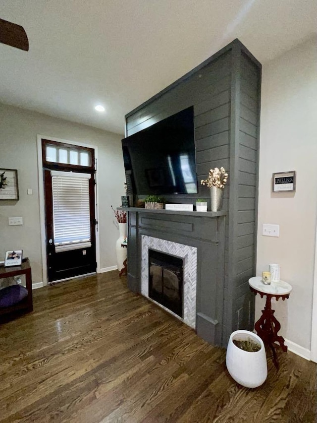 living room with a fireplace and dark hardwood / wood-style floors