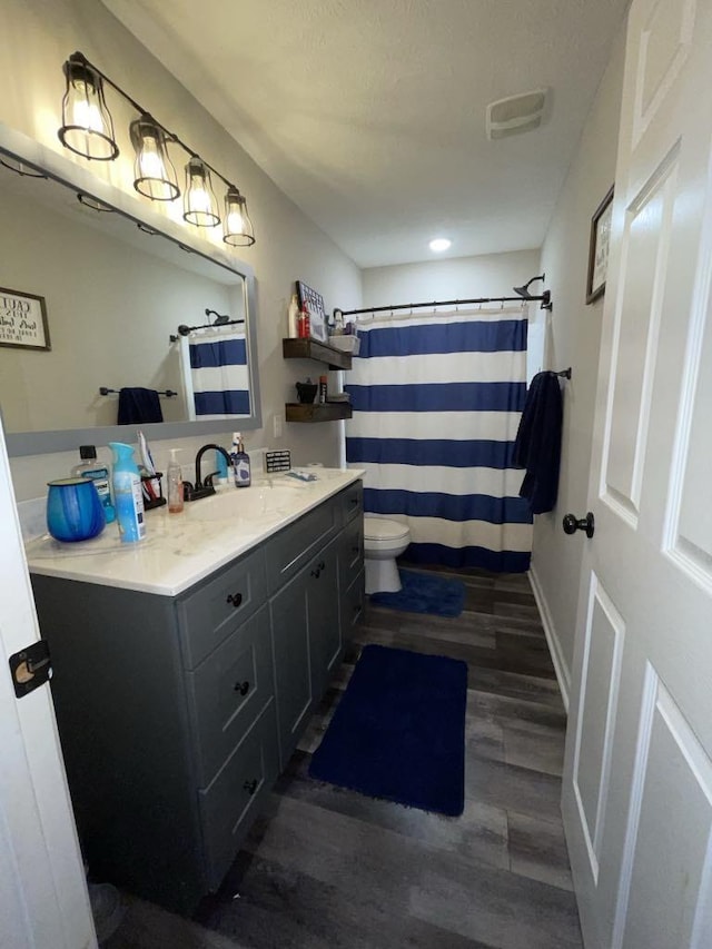 bathroom featuring vanity, a shower with curtain, wood-type flooring, and toilet