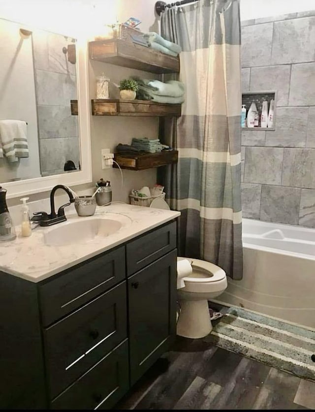 full bathroom featuring vanity, wood-type flooring, toilet, and shower / bath combo with shower curtain