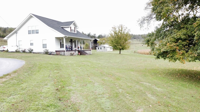 exterior space featuring a lawn and covered porch