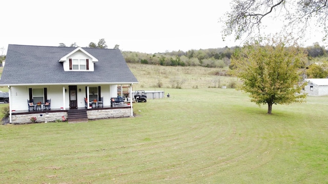 view of front facade with covered porch and a front lawn