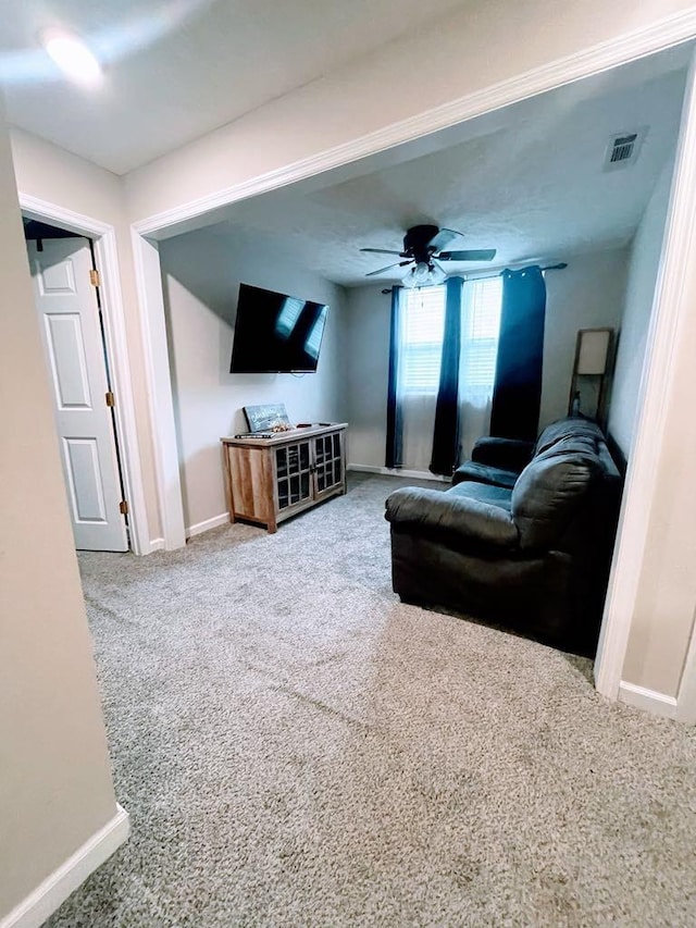 living room featuring carpet and ceiling fan