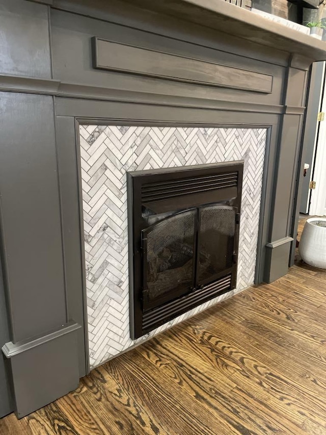 interior details featuring a tiled fireplace