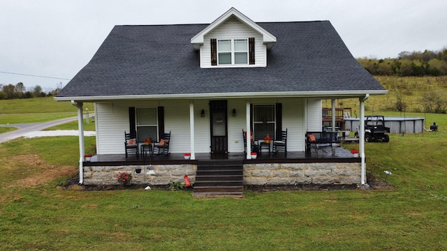 view of front of house with covered porch and a front lawn