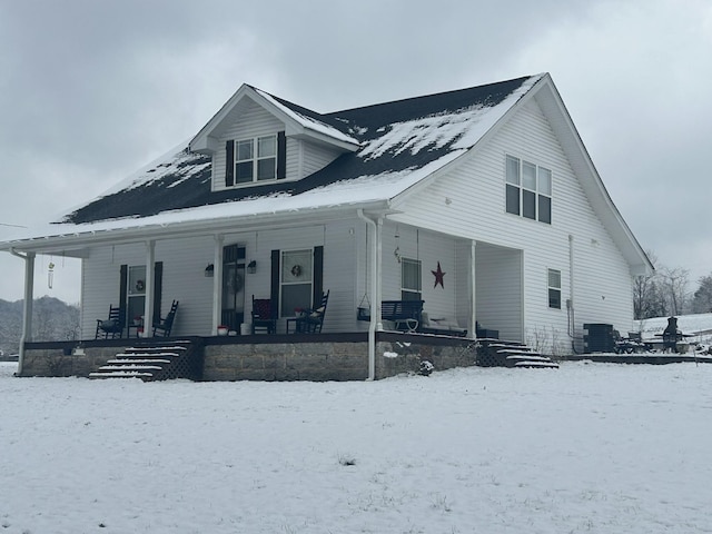 view of front of property with covered porch and central air condition unit