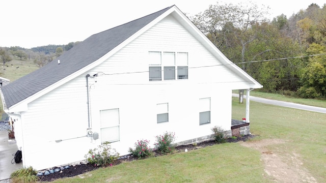 view of side of home with a lawn