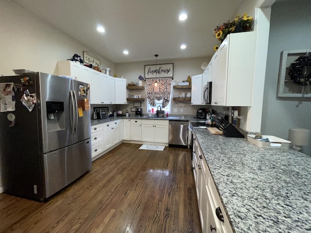 kitchen with dark hardwood / wood-style floors, white cabinetry, sink, light stone counters, and stainless steel appliances