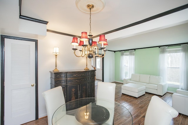 dining space featuring crown molding, hardwood / wood-style flooring, and a chandelier