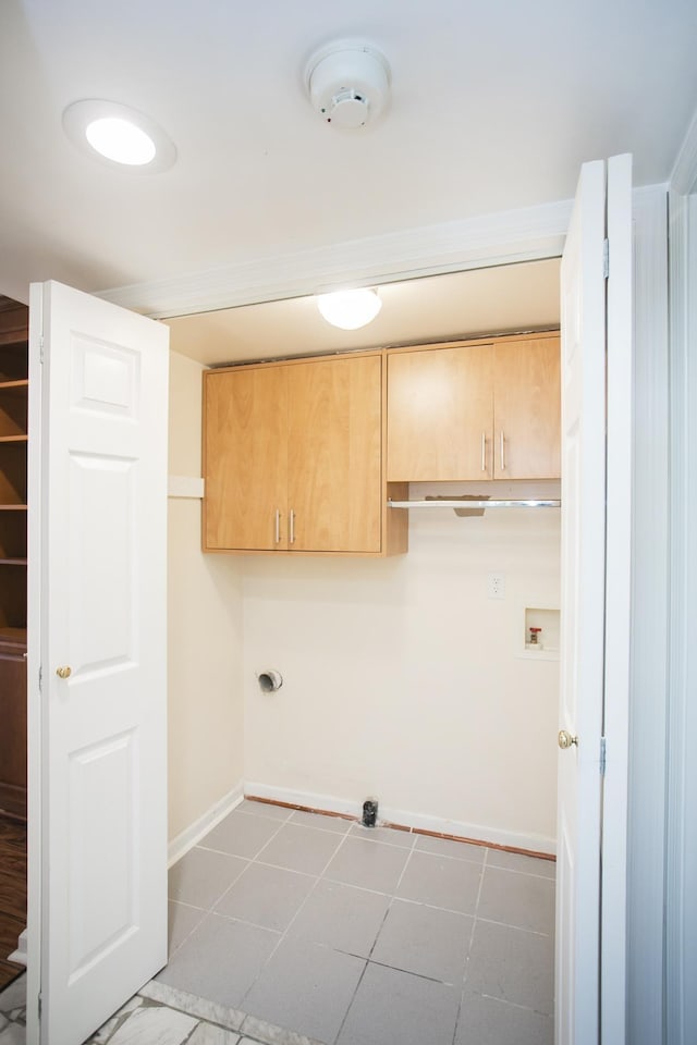 washroom with hookup for a washing machine, cabinets, and hookup for an electric dryer