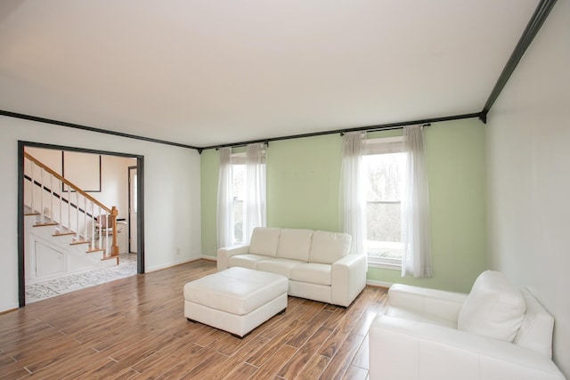 living room with hardwood / wood-style flooring and crown molding