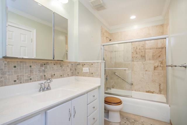 full bathroom featuring combined bath / shower with glass door, tile walls, vanity, toilet, and crown molding