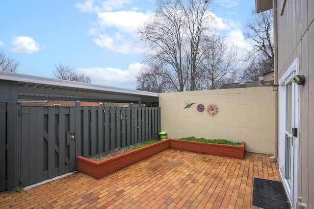 wooden terrace with a patio area