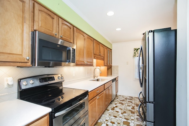 kitchen featuring tasteful backsplash, sink, ornamental molding, and stainless steel appliances