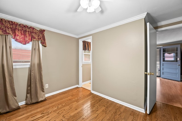 unfurnished bedroom featuring ceiling fan, ornamental molding, and wood-type flooring