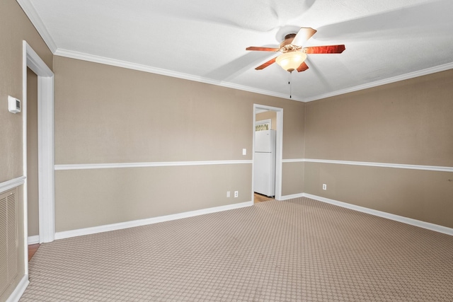 empty room with ceiling fan, light colored carpet, and crown molding