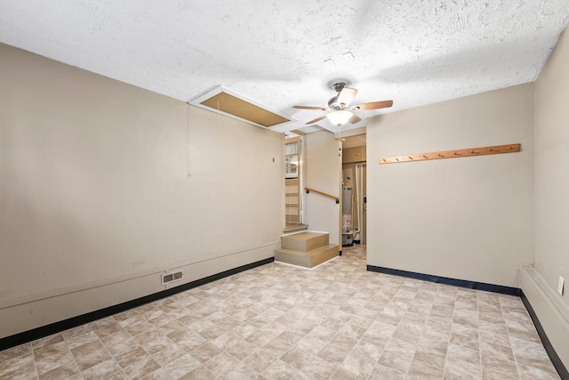 empty room featuring ceiling fan and a textured ceiling