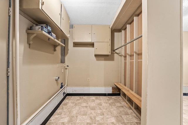 laundry room featuring cabinets