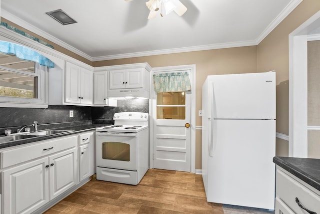 kitchen featuring tasteful backsplash, white appliances, sink, and white cabinets