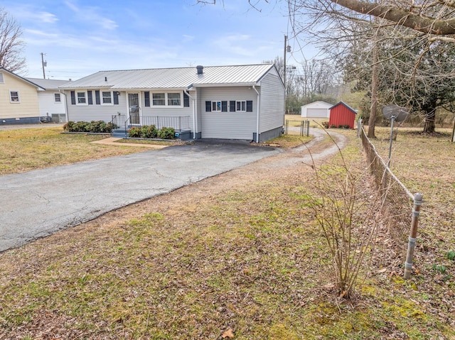 ranch-style house with an outbuilding, a garage, and a front yard