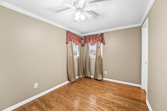 empty room with crown molding, ceiling fan, and hardwood / wood-style floors