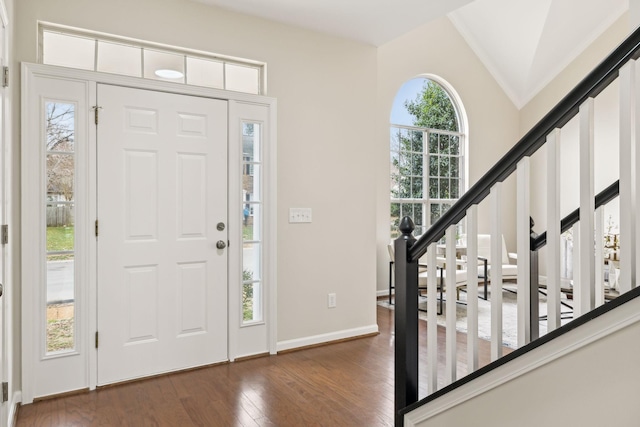 entryway with vaulted ceiling and dark hardwood / wood-style floors