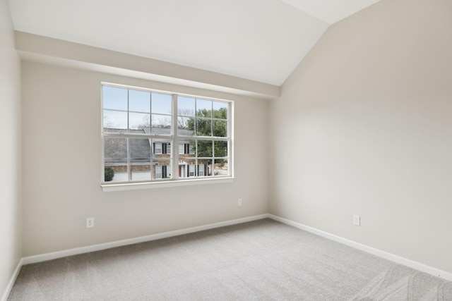 unfurnished room with vaulted ceiling and carpet floors