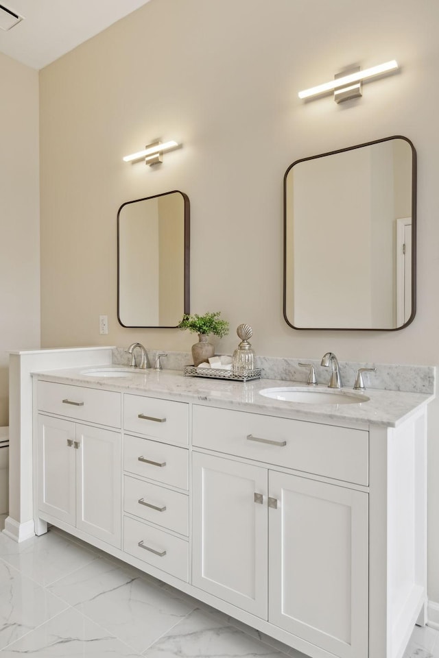 bathroom featuring vanity and toilet