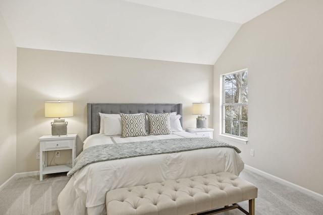 carpeted bedroom featuring lofted ceiling