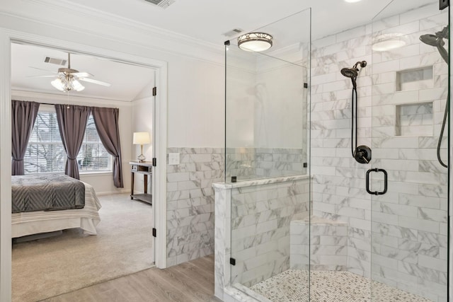 bathroom with ornamental molding, hardwood / wood-style floors, an enclosed shower, and ceiling fan