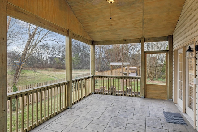 unfurnished sunroom with lofted ceiling, a healthy amount of sunlight, and wood ceiling