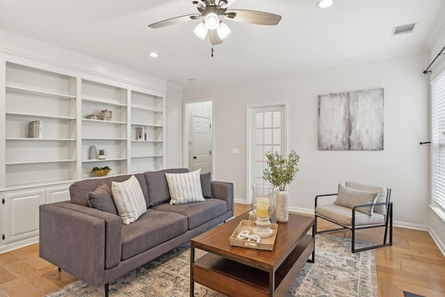 living room with ceiling fan, ornamental molding, and light wood-type flooring