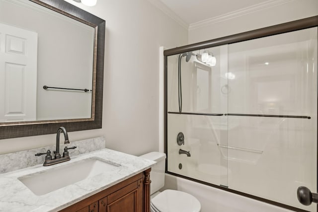 full bathroom with crown molding, enclosed tub / shower combo, vanity, and toilet