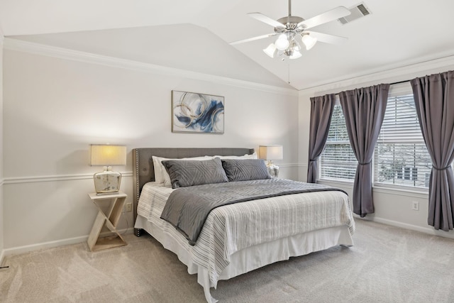 carpeted bedroom with ornamental molding, lofted ceiling, and ceiling fan