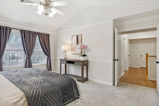 bedroom featuring ornamental molding, vaulted ceiling, light colored carpet, and ceiling fan