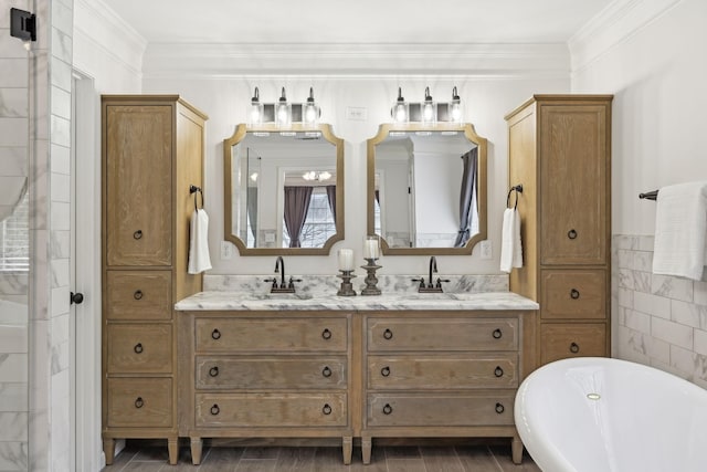 bathroom featuring tile walls, a tub to relax in, crown molding, and vanity