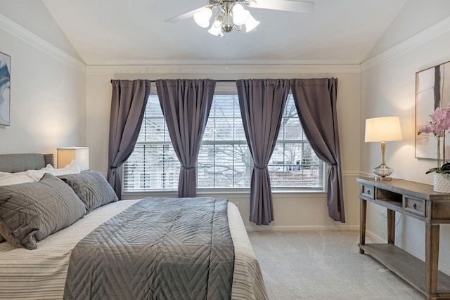 bedroom featuring crown molding, vaulted ceiling, and light colored carpet