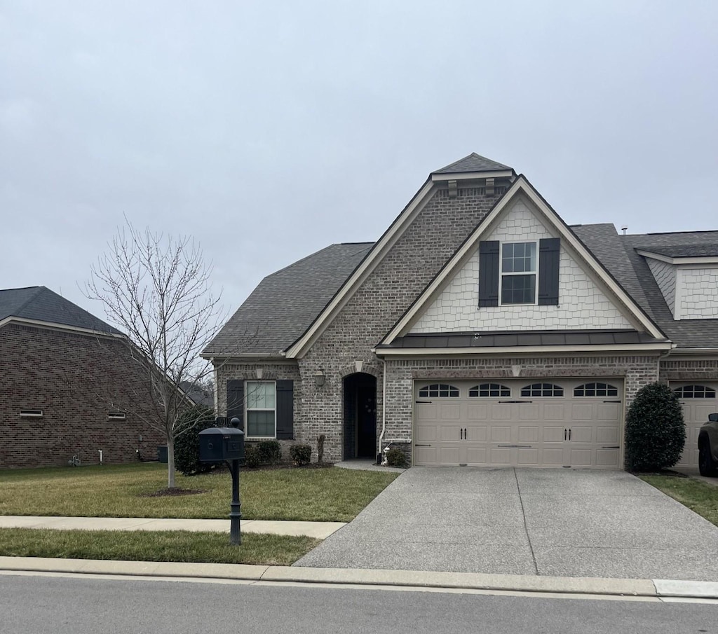 view of front facade with a garage and a front yard